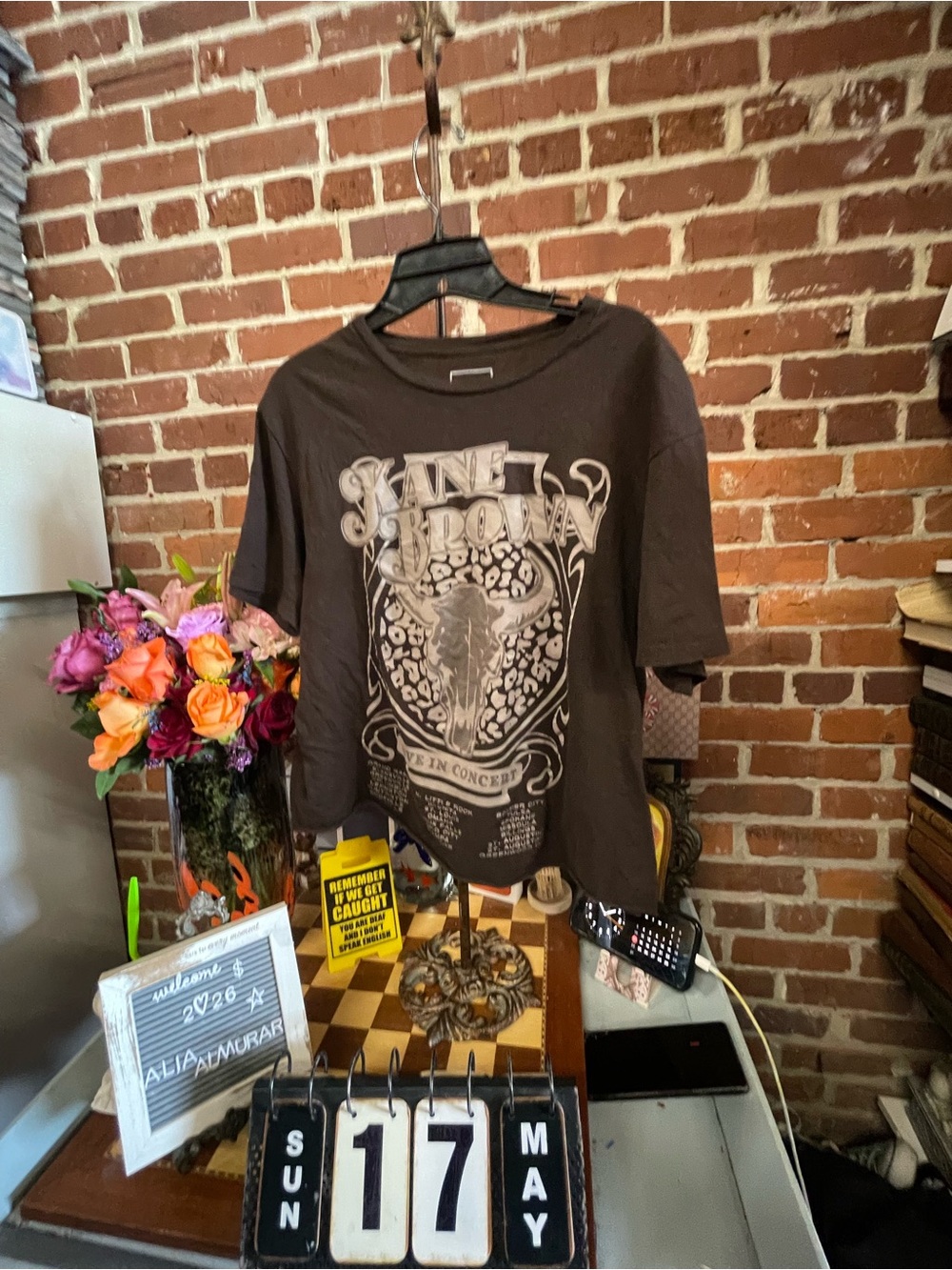 Kane Brown Live in Concert brown graphic t-shirt with a cow skull and leopard